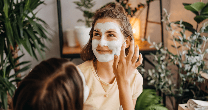 Una mujer carga a su pug mientras sonríe junto a su pareja.